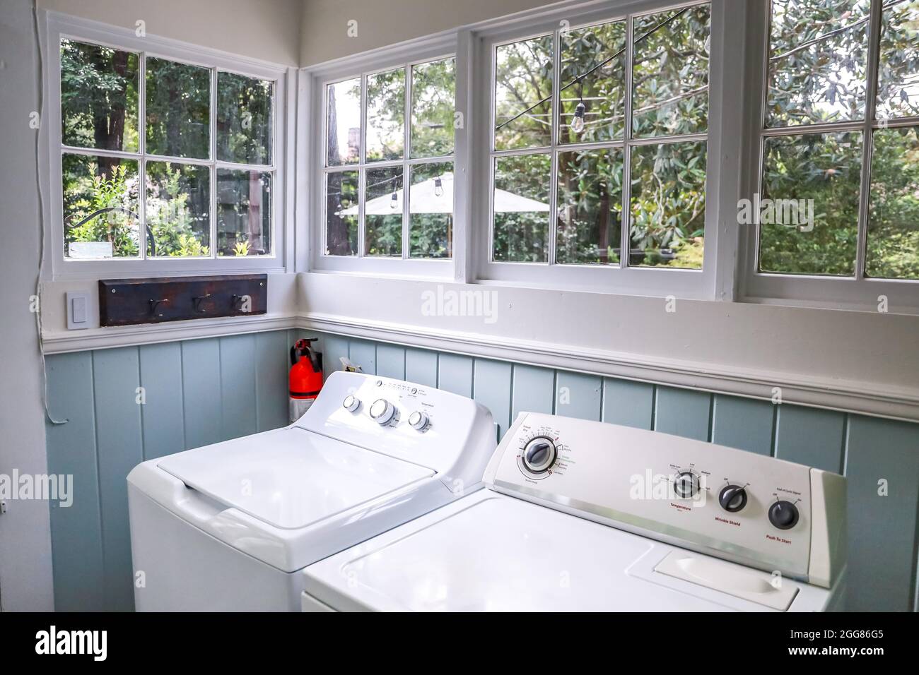 A vintage laundry room filled with windows and natural light Stock