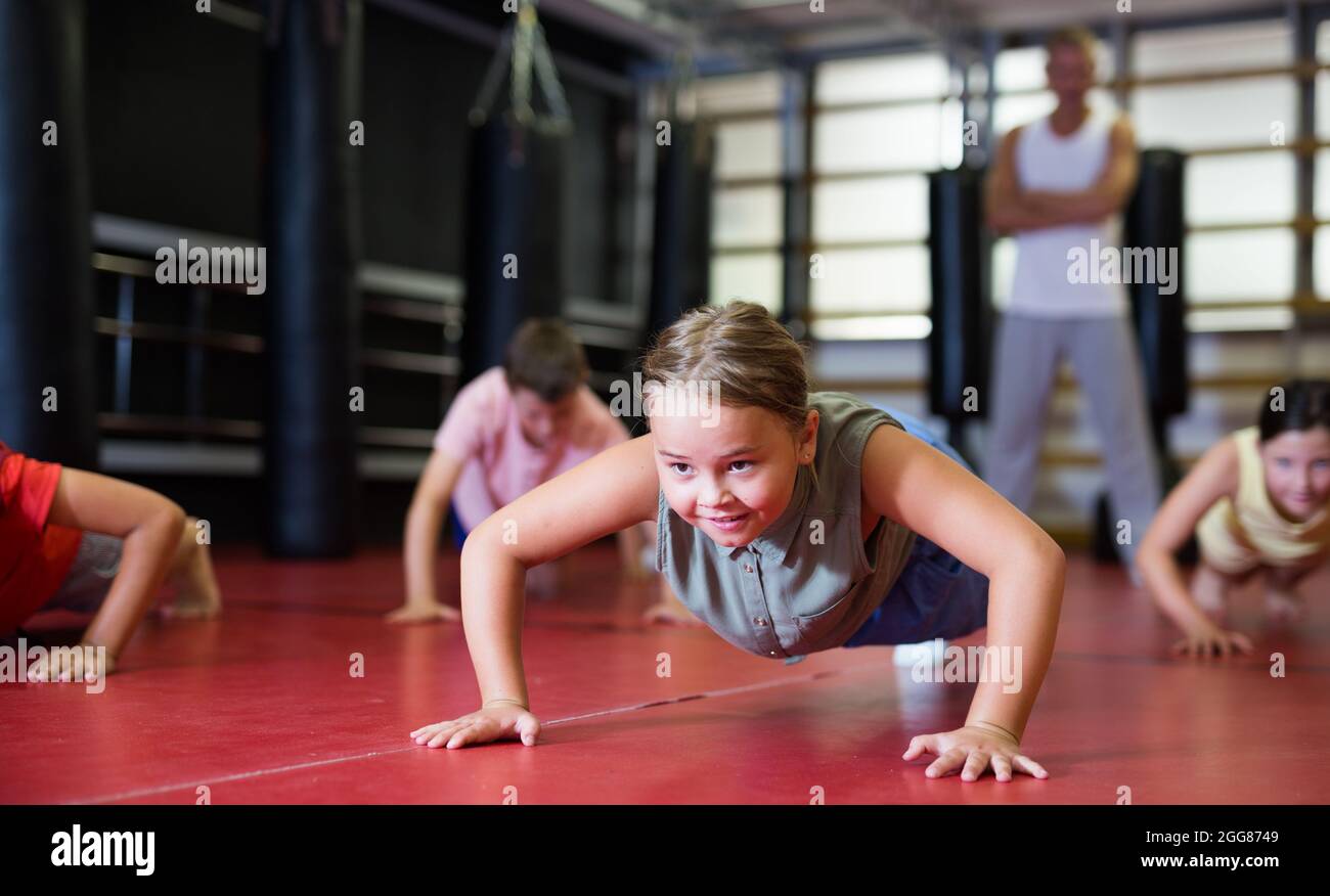 Children doing bench press exercises in gym Stock Photo Alamy