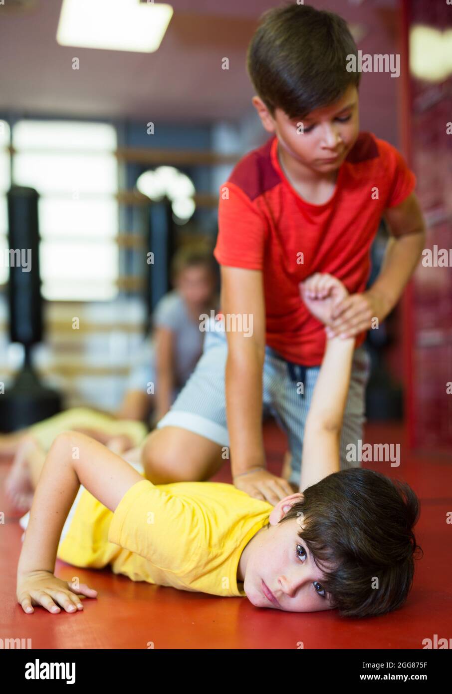 Boys training armlock move in gym Stock Photo - Alamy
