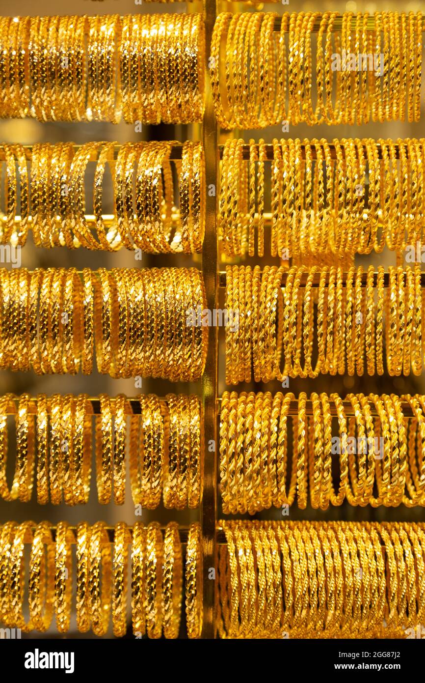 many golden jewel bracelet ring made of pure gold on jeweller display background Stock Photo