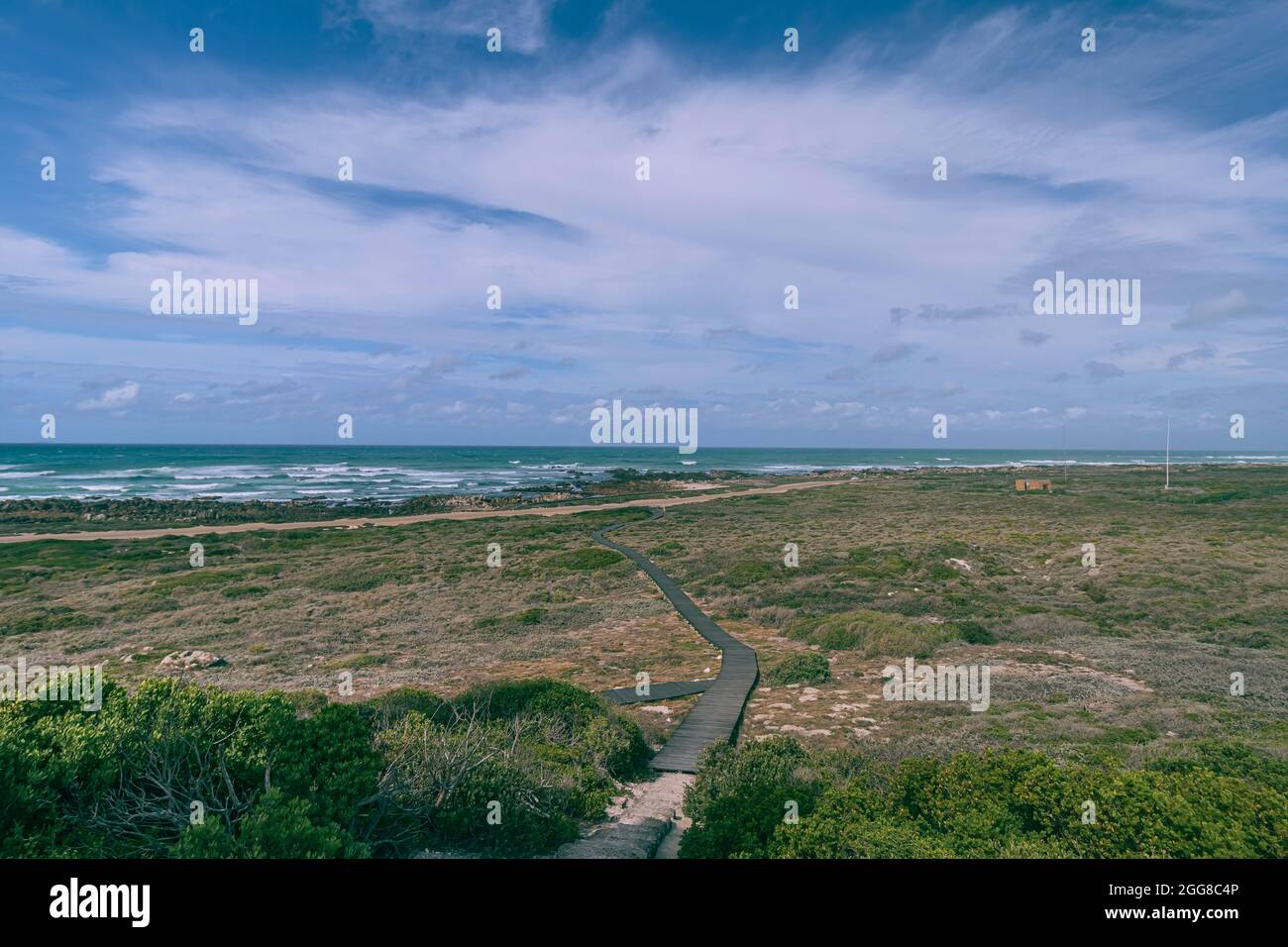 The view of coastal plain with walking plank at Cape Agulhas National Park which is the Africa continent southernmost point in South Africa. Stock Photo