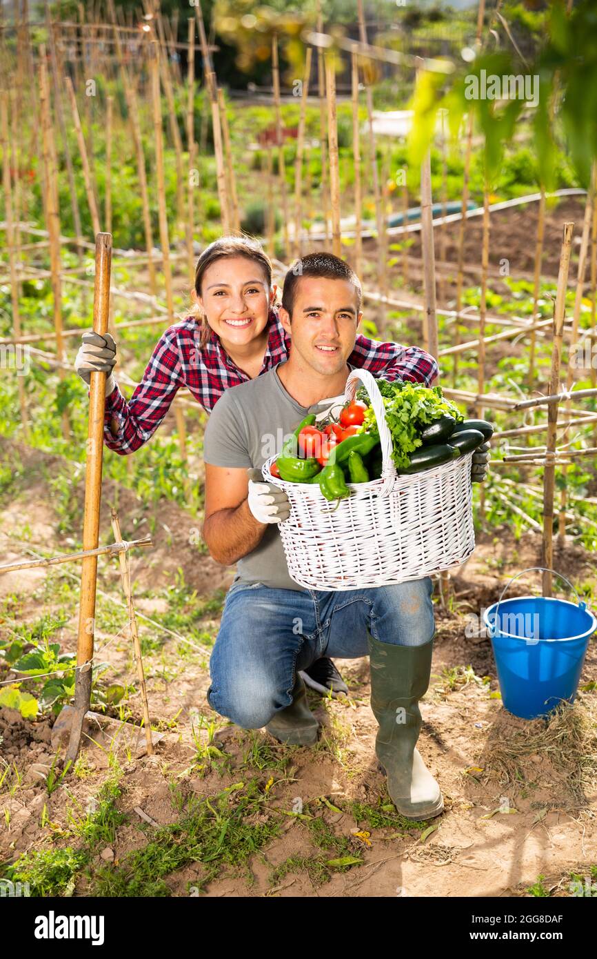 Happy married couple with crop of vegetables on farm Stock Photo - Alamy