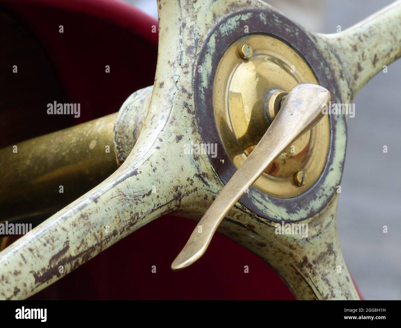 Brass wheel hub with clamping lever of an old four-spoke steering wheel of a historic racing car Stock Photo
