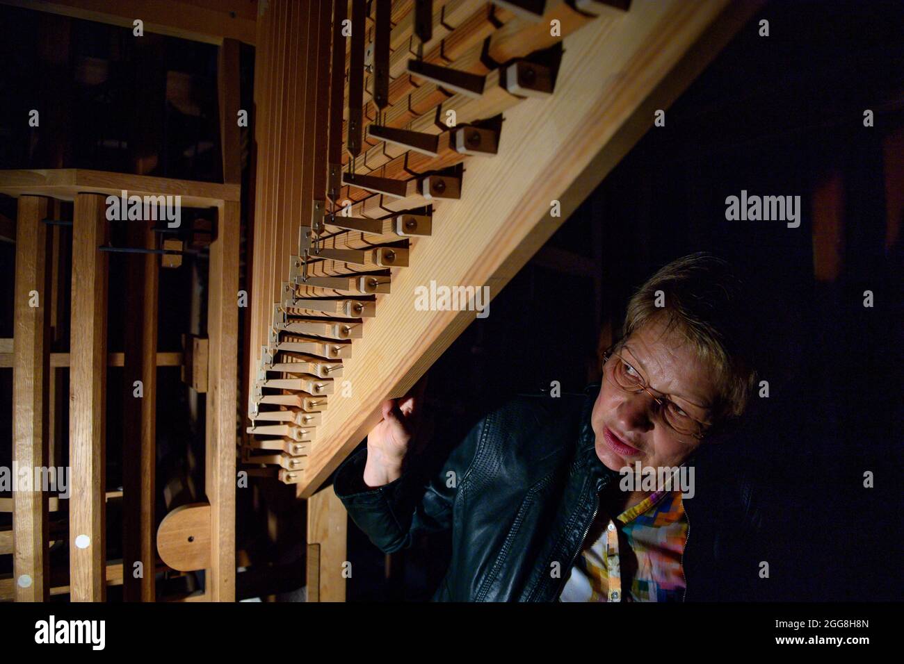 26 August 2021, Saxony-Anhalt, Halberstadt: Carmen Presch, representative for the organ project at the Förderkreis Musik am Dom zu Halberstadt inside the Jesse organ in the Moritzkirche. The organ building company Hüfken had added four stops to the musical instrument. For this purpose, 89 historic pipes were restored and 67 pipes that no longer exist were reconstructed. The new stops will be put into service in a service on 01 September 2021. From 11 to 12 September 2021 the 7th Halberstadt Organ Day will take place. The slider chest organ was completed in 1787 by the Halberstadt master builde Stock Photo