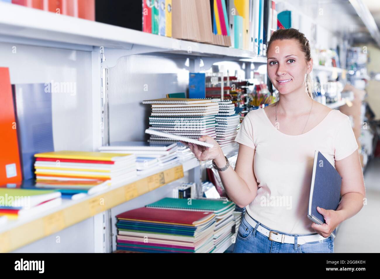 Female choosing color notebook in stationery store Stock Photo Alamy