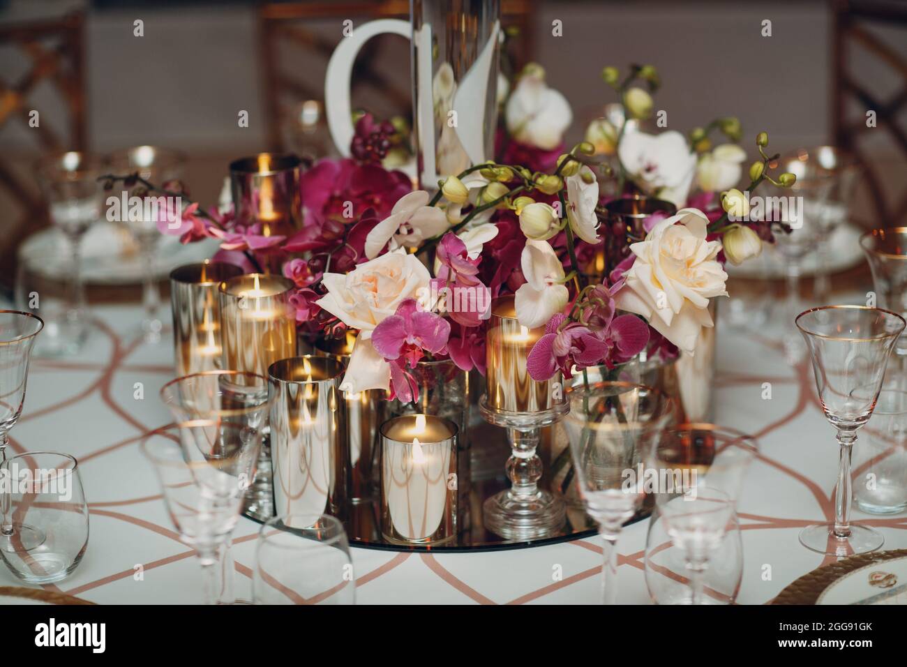Wedding decor table with white flowers and candles Stock Photo - Alamy