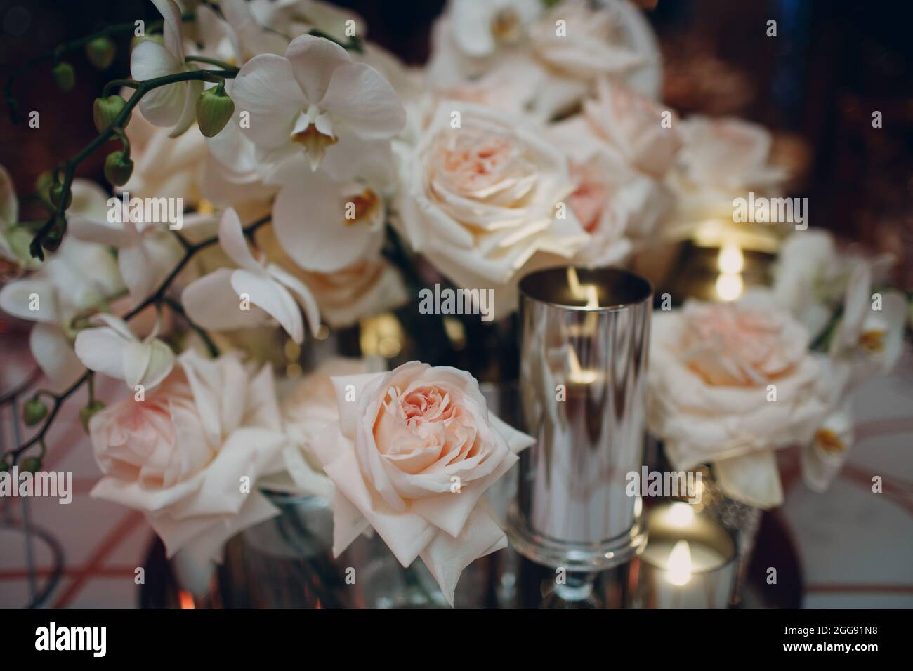 Wedding decor table with white flowers and candles Stock Photo - Alamy