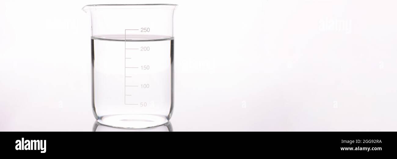 Sterilized water is poured into measuring glass closeup Stock Photo