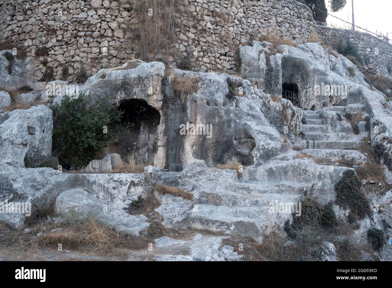 View of ancient rock cut burial chambers that were reused by generations of families from as early as the seventh until the fifth century BC in Valley of Hinnom the modern name for the biblical Gehenna or Gehinnom valley surrounding Jerusalem's Old City, Israel Stock Photo