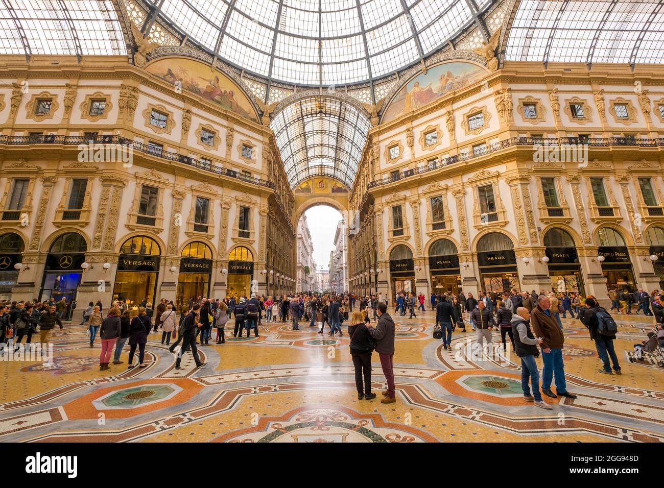 People strolling and shopping through the center of the arcade. At the Galleria Vittorio Emanuele II in Milan, Italy. Stock Photo