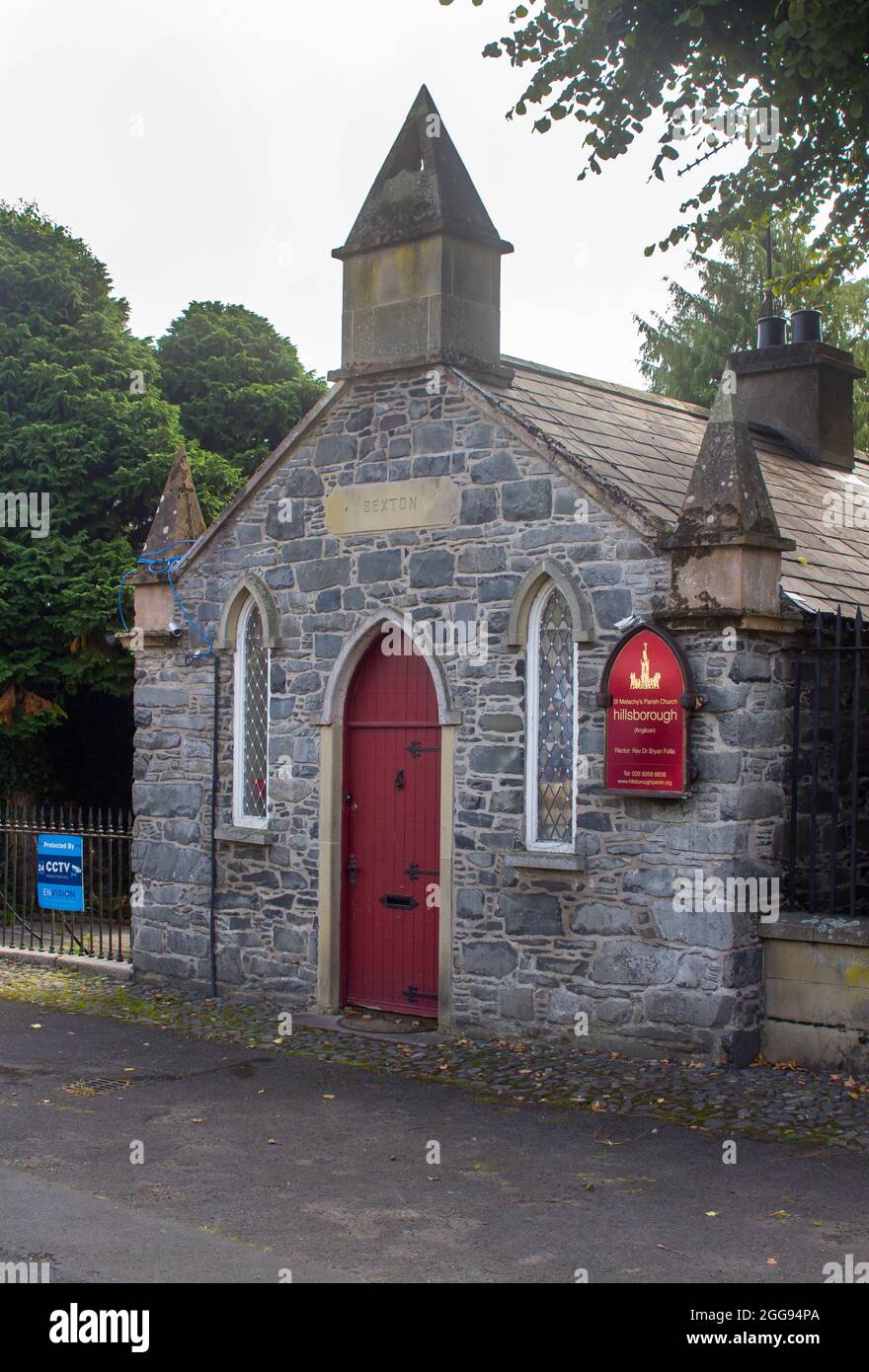 26 August 2021 The Sexton's building at the gateway to grounds of St Malachy's Parish Church in Hillsborough a village with Royal status in County Dow Stock Photo