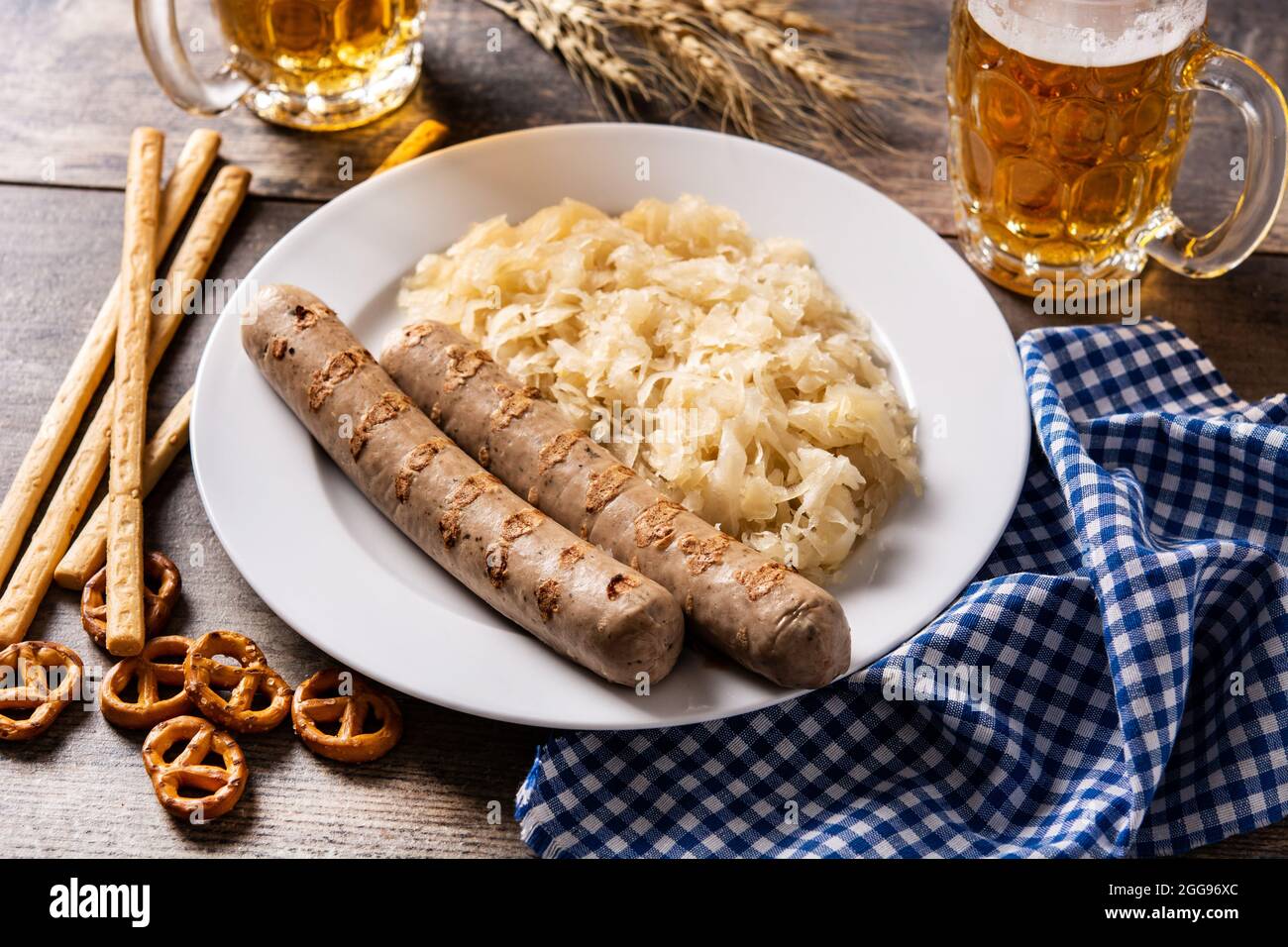 Bratwurst sausage ,sauerkraut, pretzels and beer on wooden table Stock