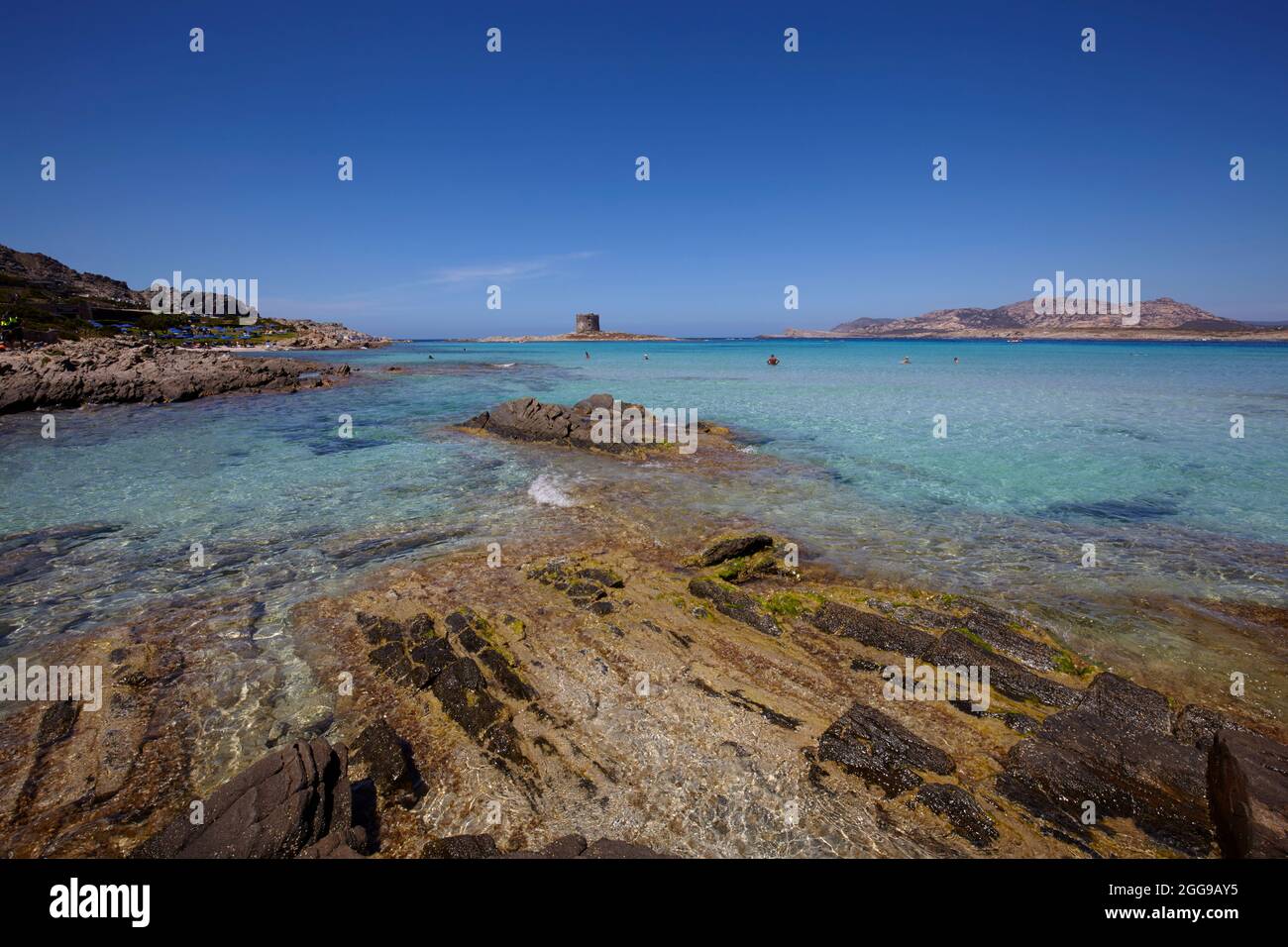 The sea in Stintino with La Pelosa tower, Sardinia, Italy Stock Photo