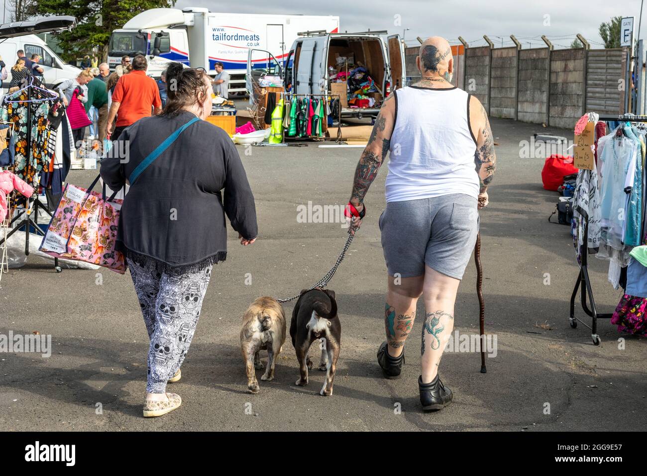 Husband, wife and two dogs at the car boot sale and open market, Ayr racecourse, Ayr, Scotland, UK Stock Photo