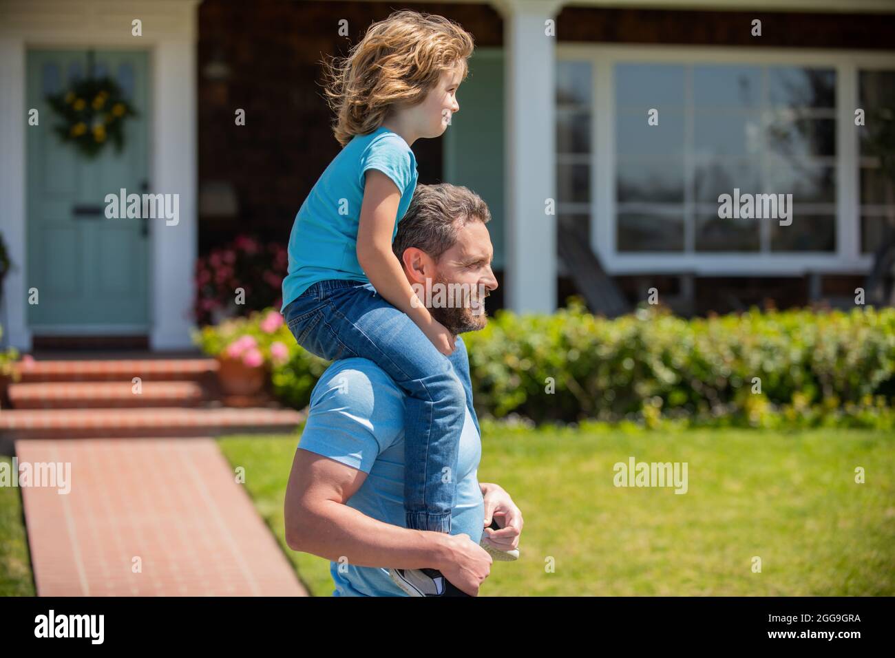 happy father carry son near house. family value. childhood and parenthood. Stock Photo