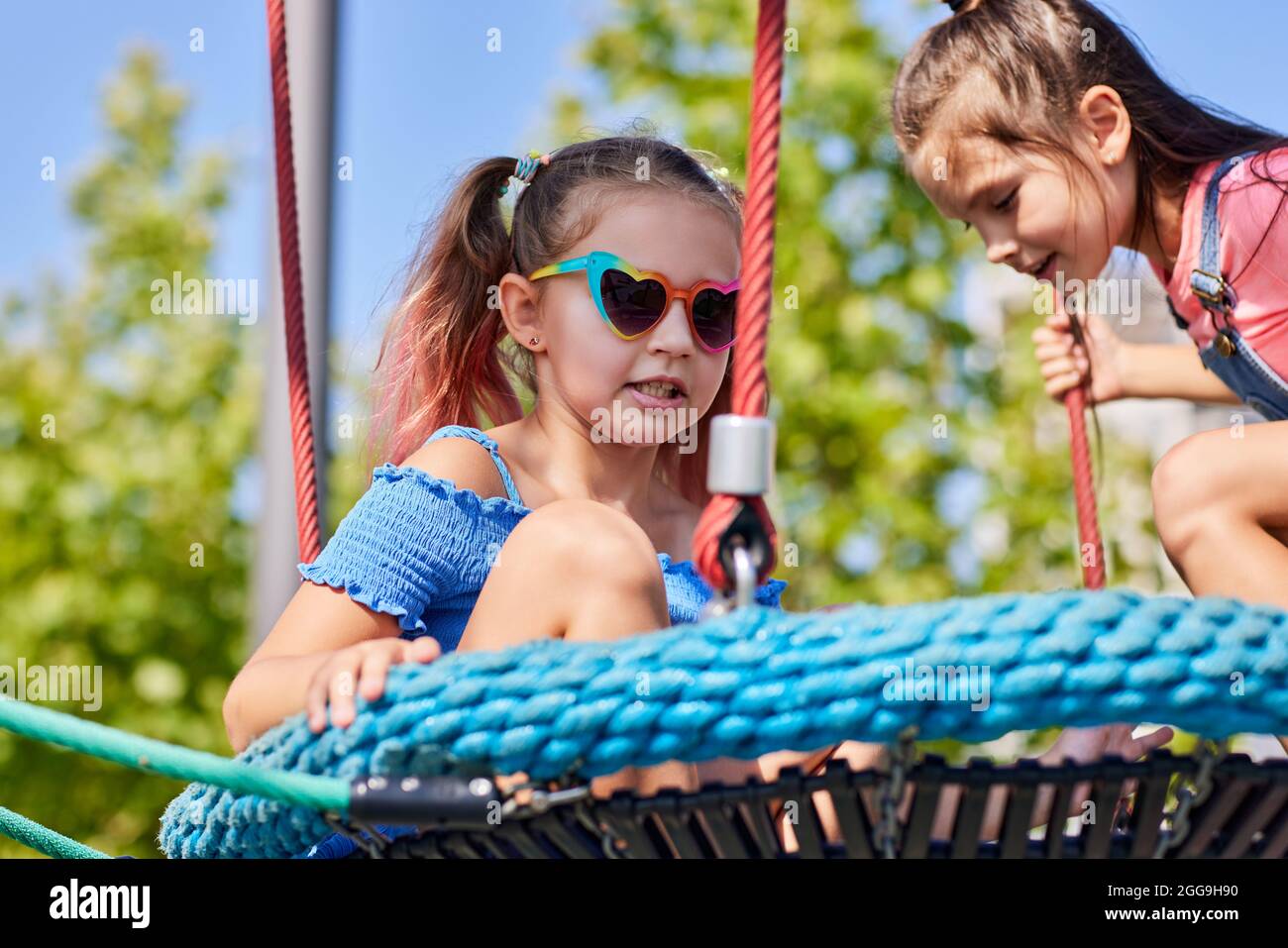 child girl having fun on playground in sunny day Stock Photo - Alamy