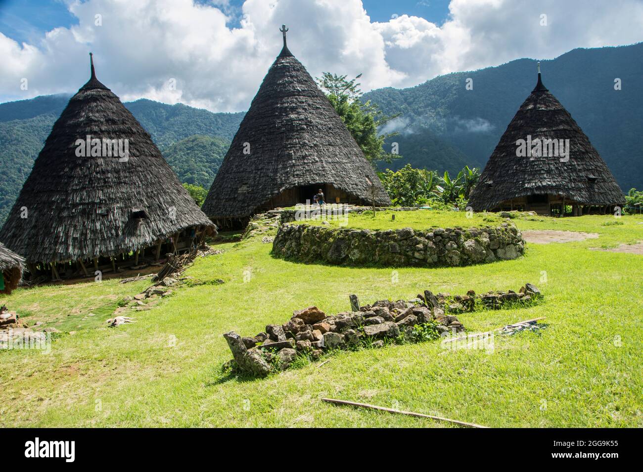 Elevated altar (Compang) in front of the conical houses of the ...