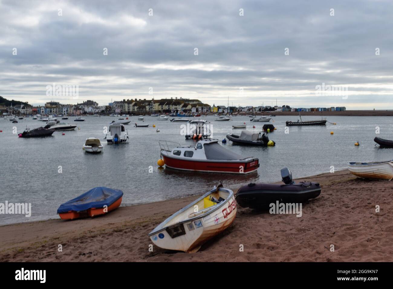 Shaldon Beach is littered with boats moored along the foreshore. Shaldon is opposite Teignmouth at the mouth of the Teign Estuary. Stock Photo