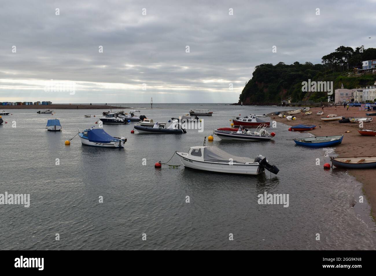 Shaldon Beach is littered with boats moored along the foreshore. Shaldon is opposite Teignmouth at the mouth of the Teign Estuary. Stock Photo