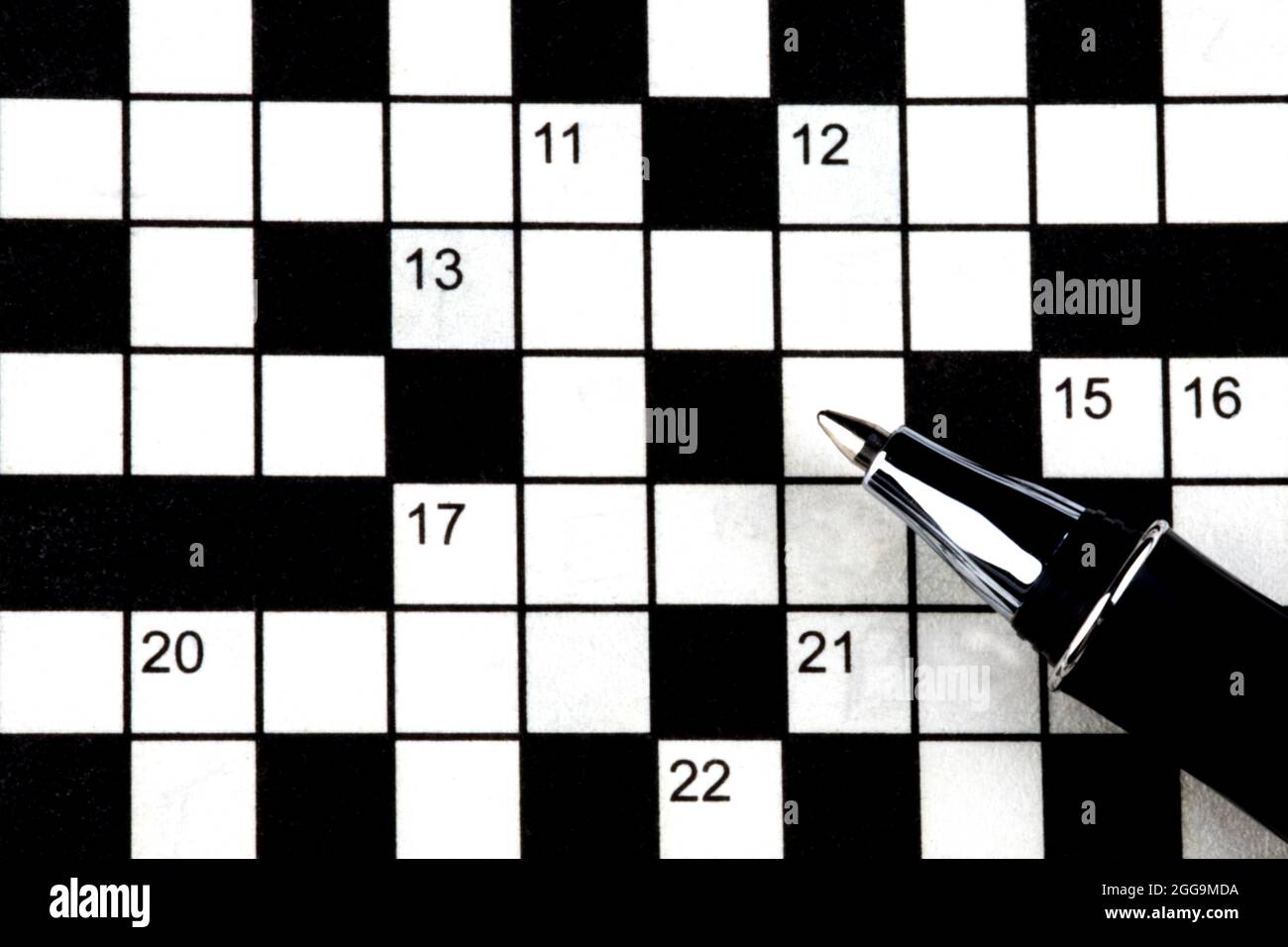 Closeup of crossword puzzle and roller ball pen Stock Photo