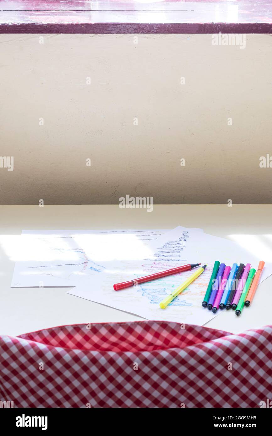 https://c8.alamy.com/comp/2GG9MH5/photograph-of-colour-ed-markers-and-a-drawing-of-a-child-on-a-table-in-a-classroom-of-a-nursery-schoolthe-photo-is-taken-in-vertical-format-2GG9MH5.jpg