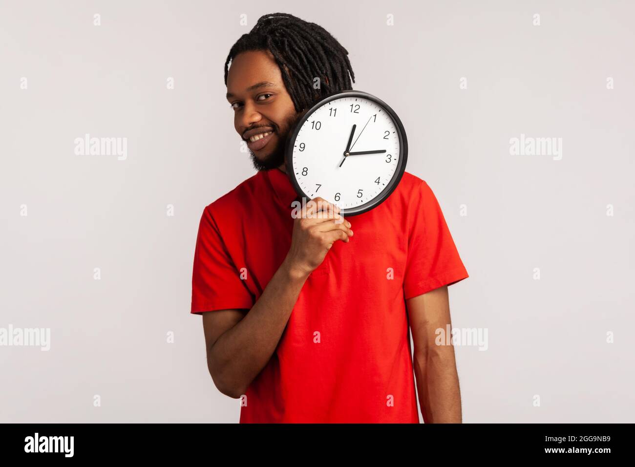 Portrait of attractive positive man with dreadlocks and beard wearing ...