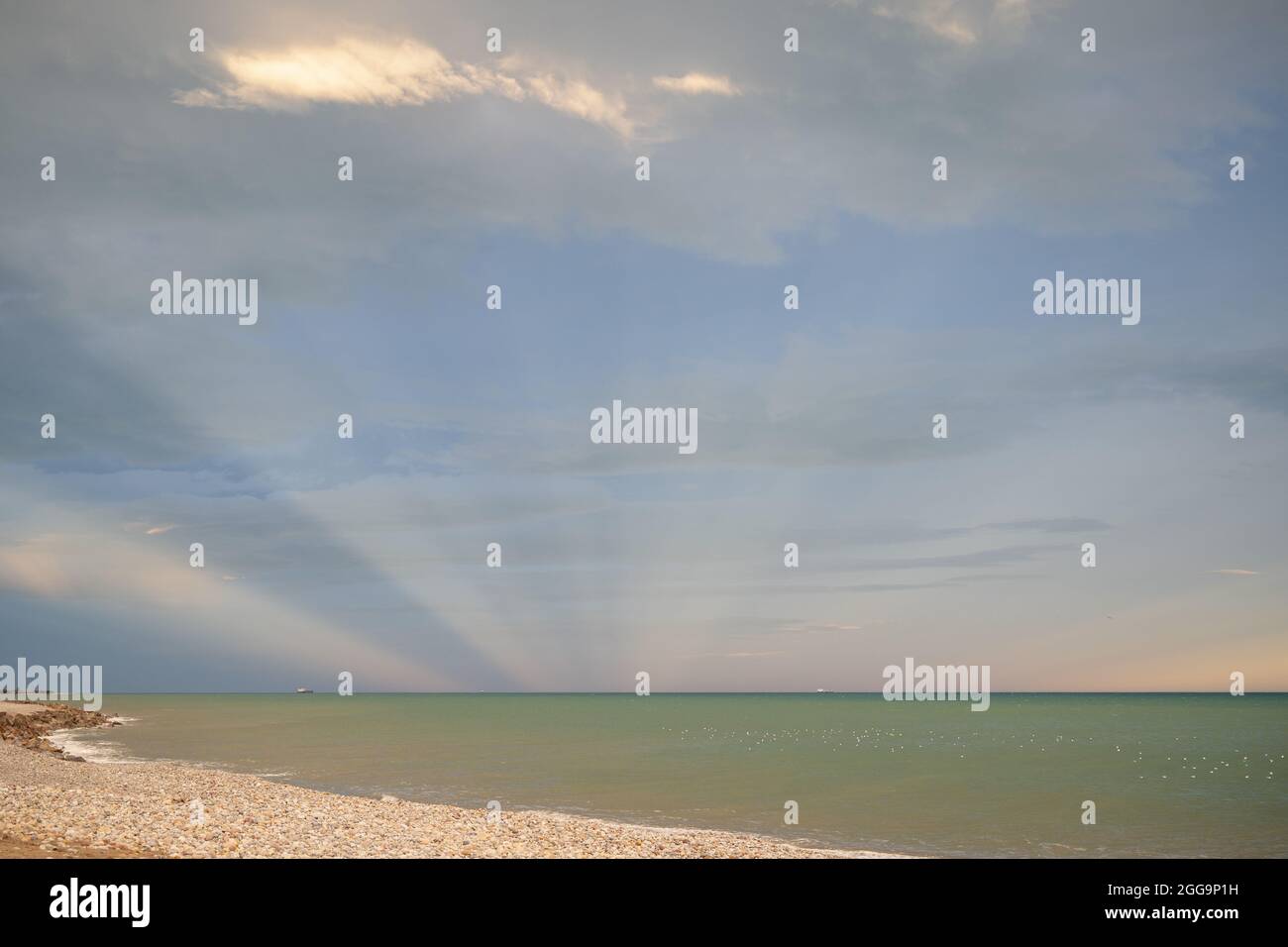 Beautiful peaceful sea under a blue sky with clouds during the sunrise ...