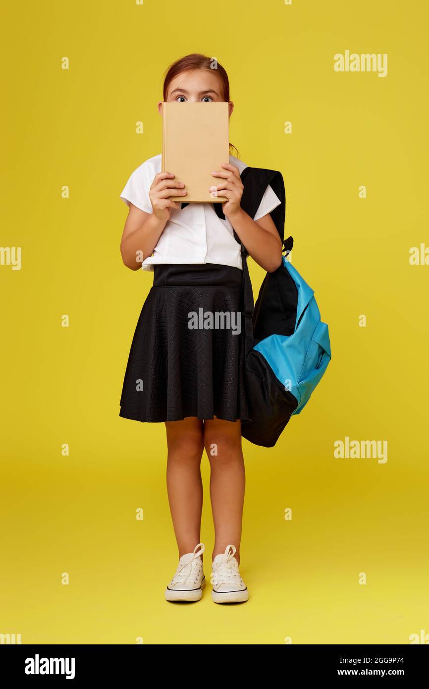cute happy schoolgirl with backpack and book Stock Photo - Alamy