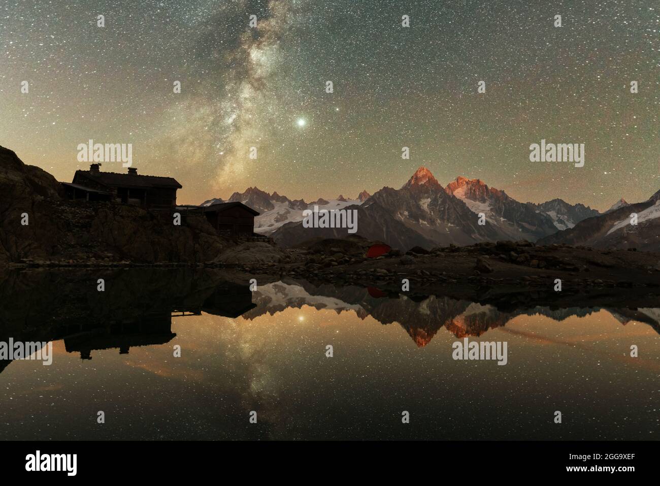 Incredible night view of Lac Blanc lake in France Alps. Monte Bianco mountain range on background. Vallon de Berard Nature Preserve, Chamonix, Graian Alps. Landscape astrophotography Stock Photo