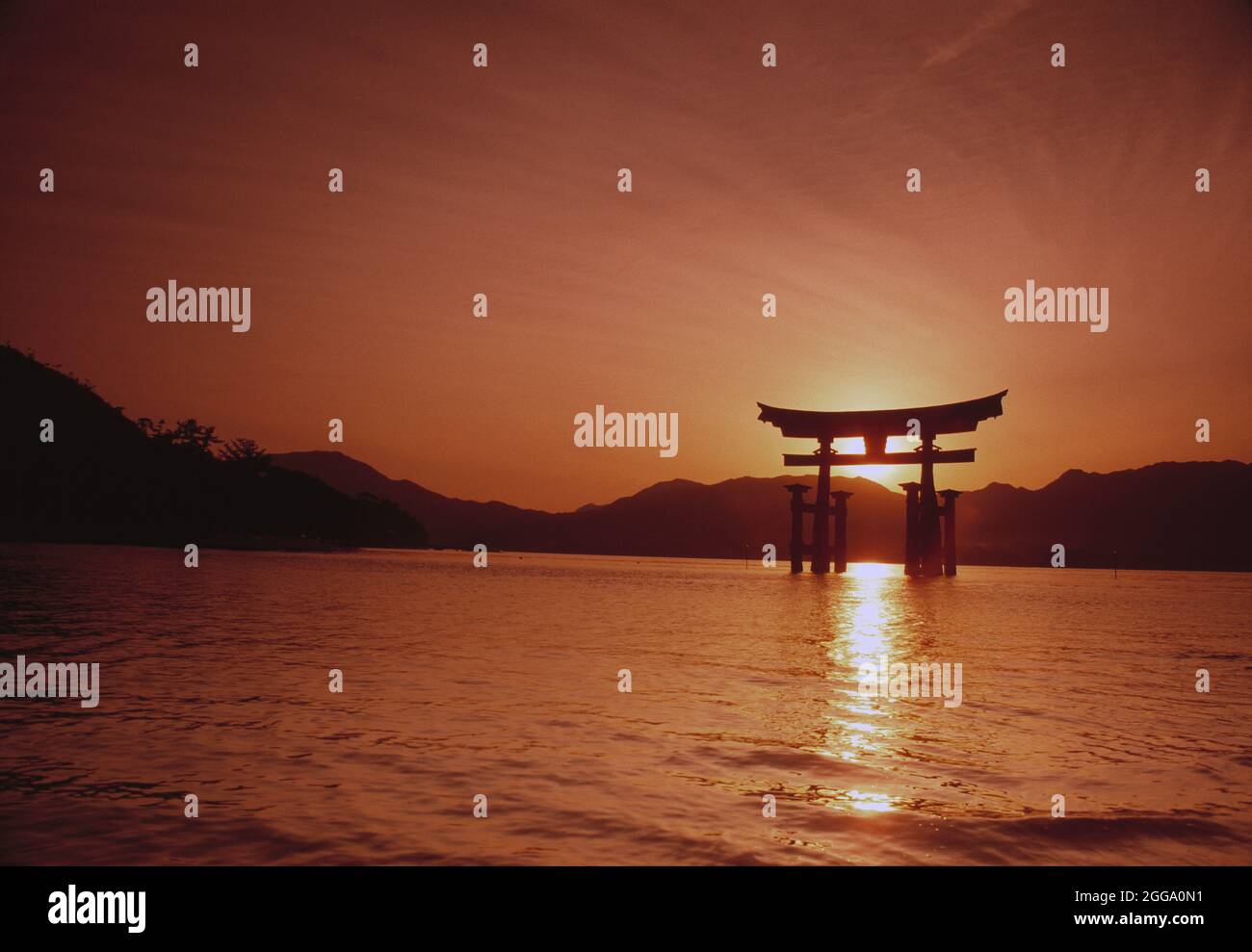 Japan. Hiroshima. Itsukushima Shrine. Torii Gate at sunset. Stock Photo