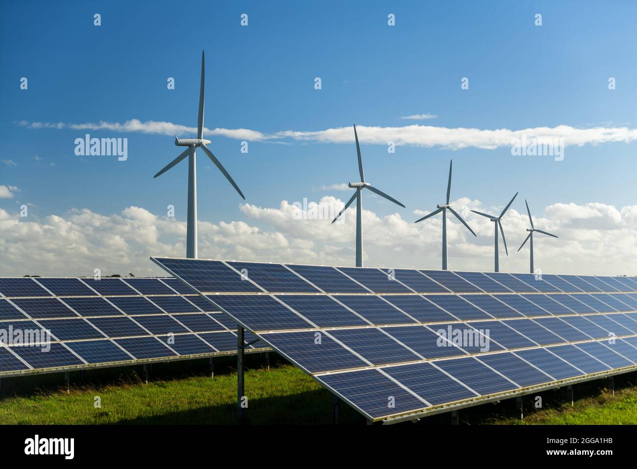 Wind turbine and solar panels energy generaters on wind farm Stock Photo