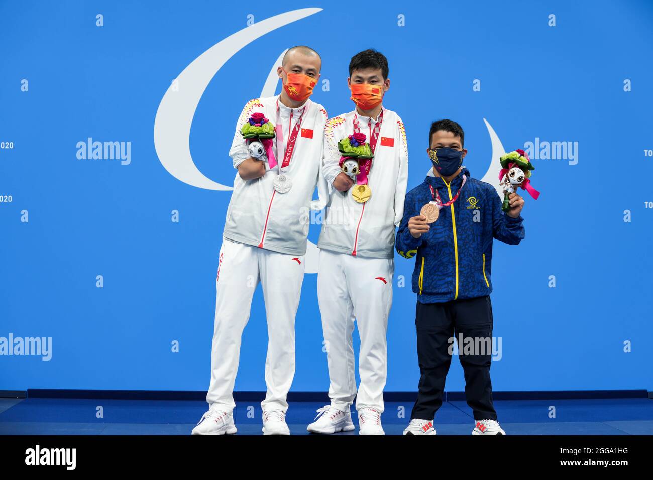 Tokyo, Japan. 30th Aug, 2021. Jia Hongguang, Wang Jingang of China and  Nelson Crispin Corzo of Venezuela (L to R) attend the medal ceremony of the  men's 50m butterfly S6 final of