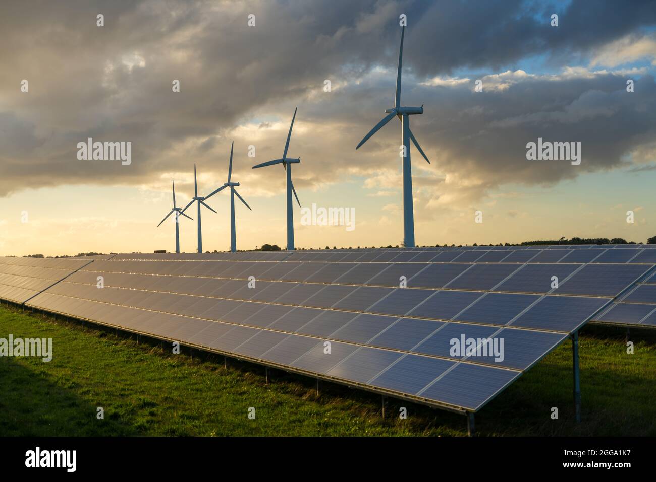 Wind turbine and solar panels energy generaters on wind farm Stock Photo
