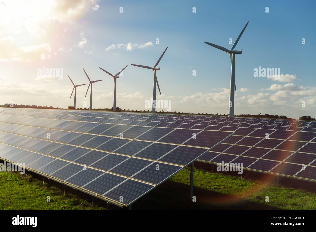 Wind turbine and solar panels energy generaters on wind farm Stock Photo