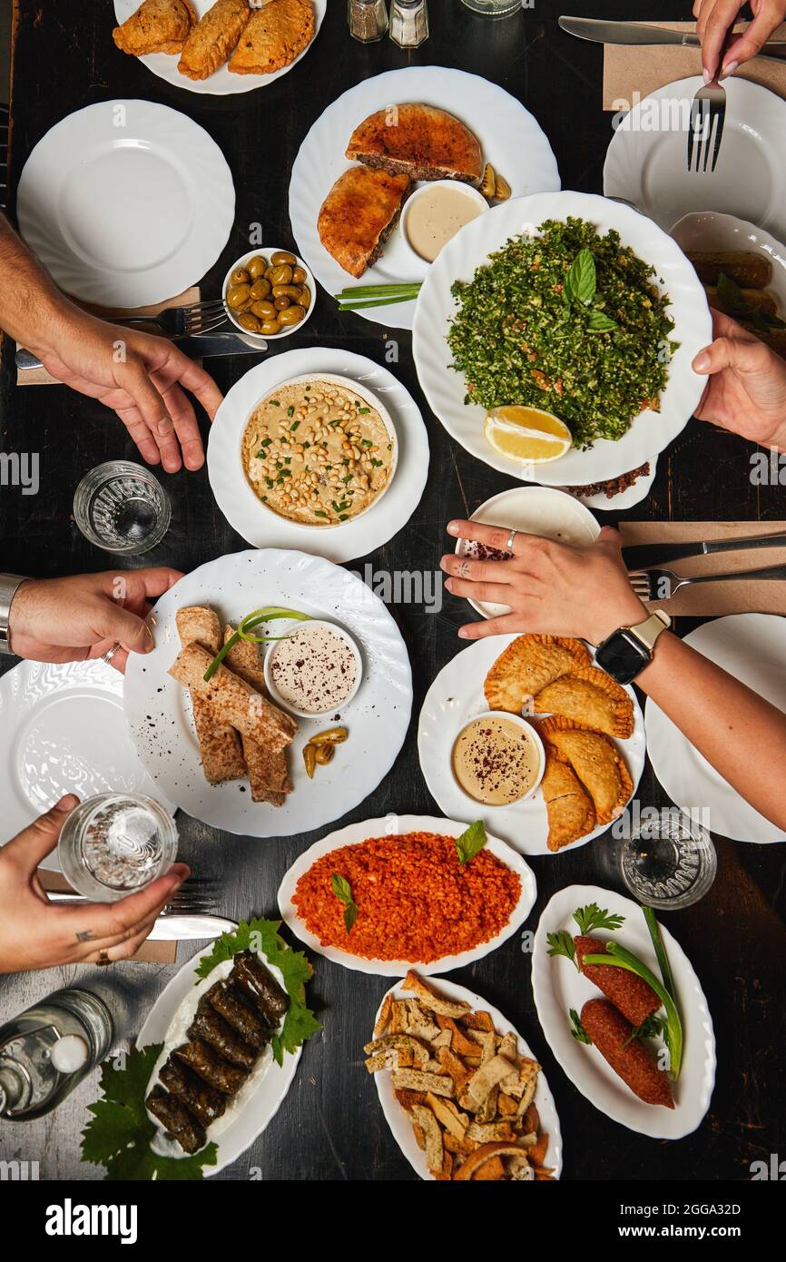 traditional Palestinian, arabic food top view with hands in a restaurant Stock Photo