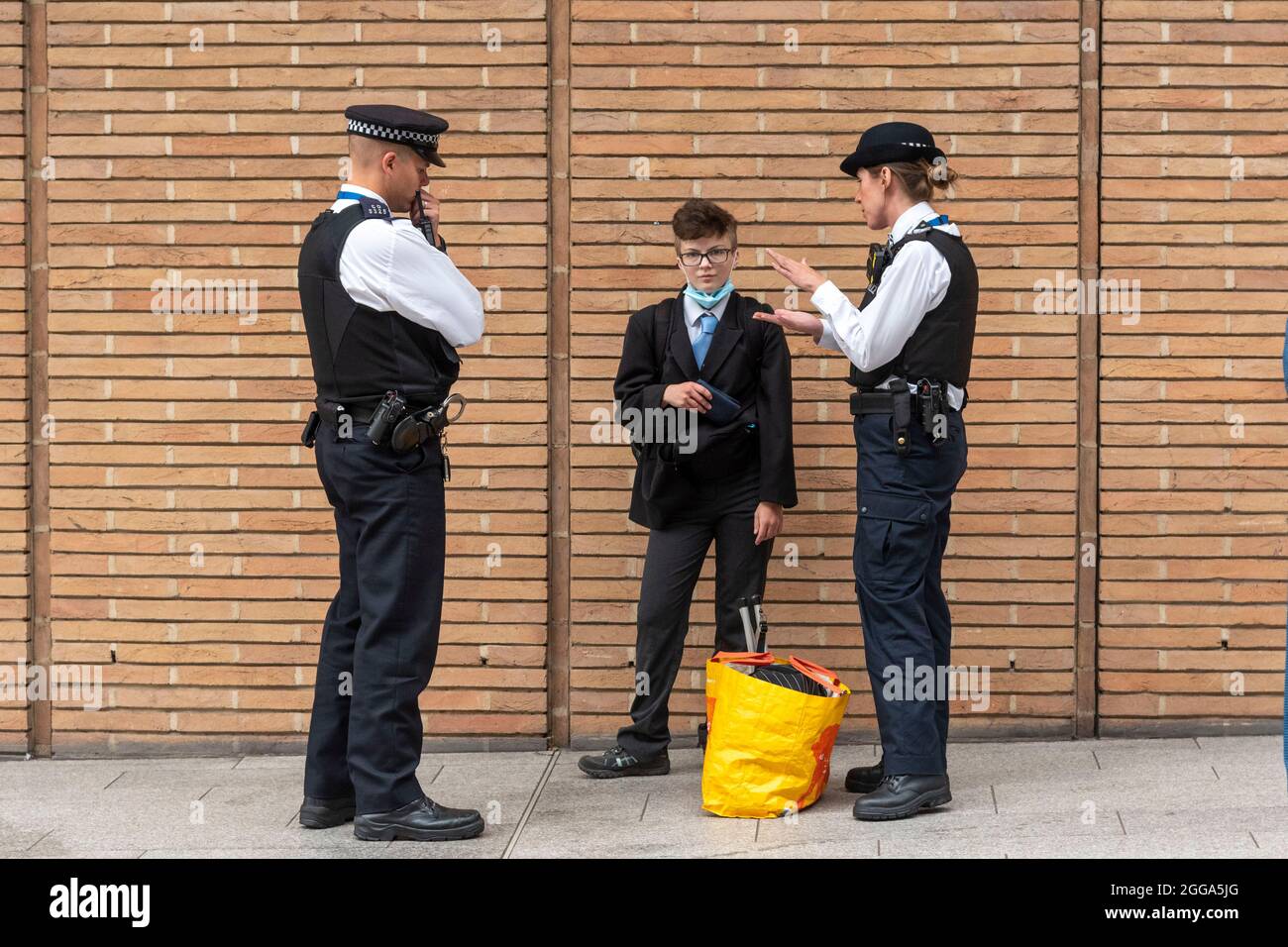 London, UK. 30th Aug, 2021. Police stop and search an activist at the News Corp building during the Extinction Rebellion protest as they hold 'The Impossible Tea Party' in London. Credit: SOPA Images Limited/Alamy Live News Stock Photo