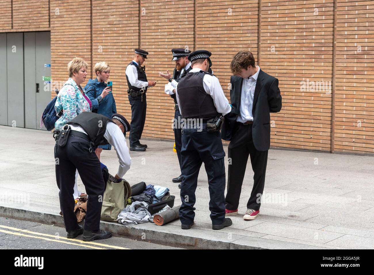 London, UK. 30th Aug, 2021. Police stop and search activists at the News Corp building during the Extinction Rebellion protest as they hold 'The Impossible Tea Party' in London. Credit: SOPA Images Limited/Alamy Live News Stock Photo