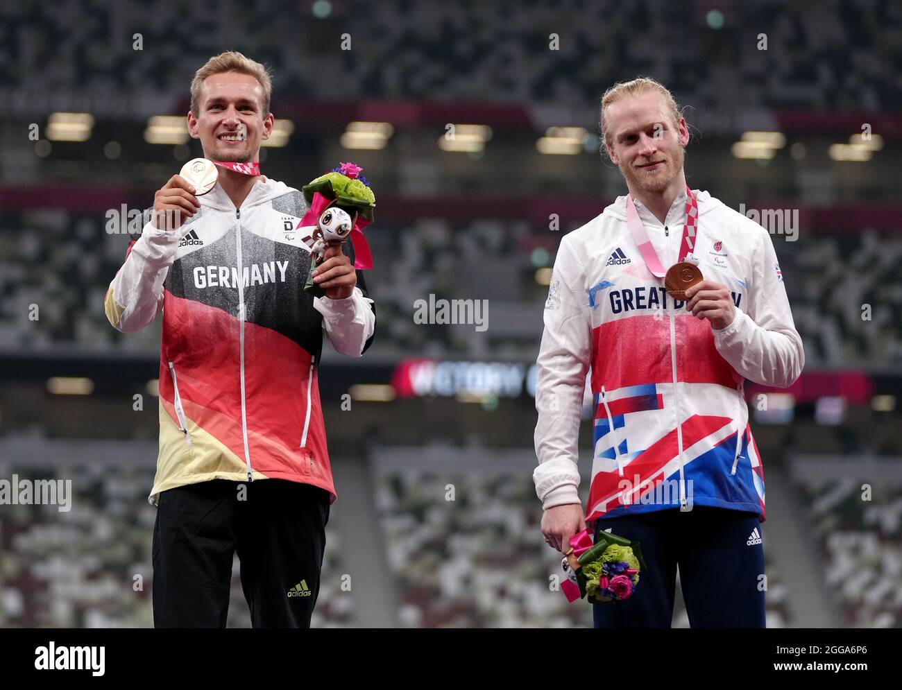 Great Britain's Jonnie Peacock with his Bronze medal alongside joint Bronze medal winner Germany’s Johannes Floors for the Men's 100m - T64 during the Athletics at the Olympic Stadium on day six of the Tokyo 2020 Paralympic Games in Japan. Picture date: Monday August 30, 2021. Stock Photo