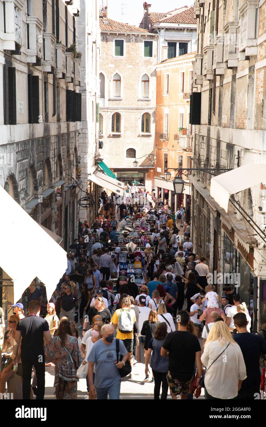 Tourists and people walking in the streets of Venice Stock Photo