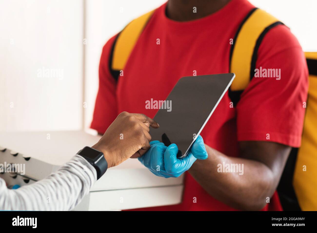 Lady Scanning Fingerprint On Digital Tablet Receiving Pizza Indoor, Cropped Stock Photo