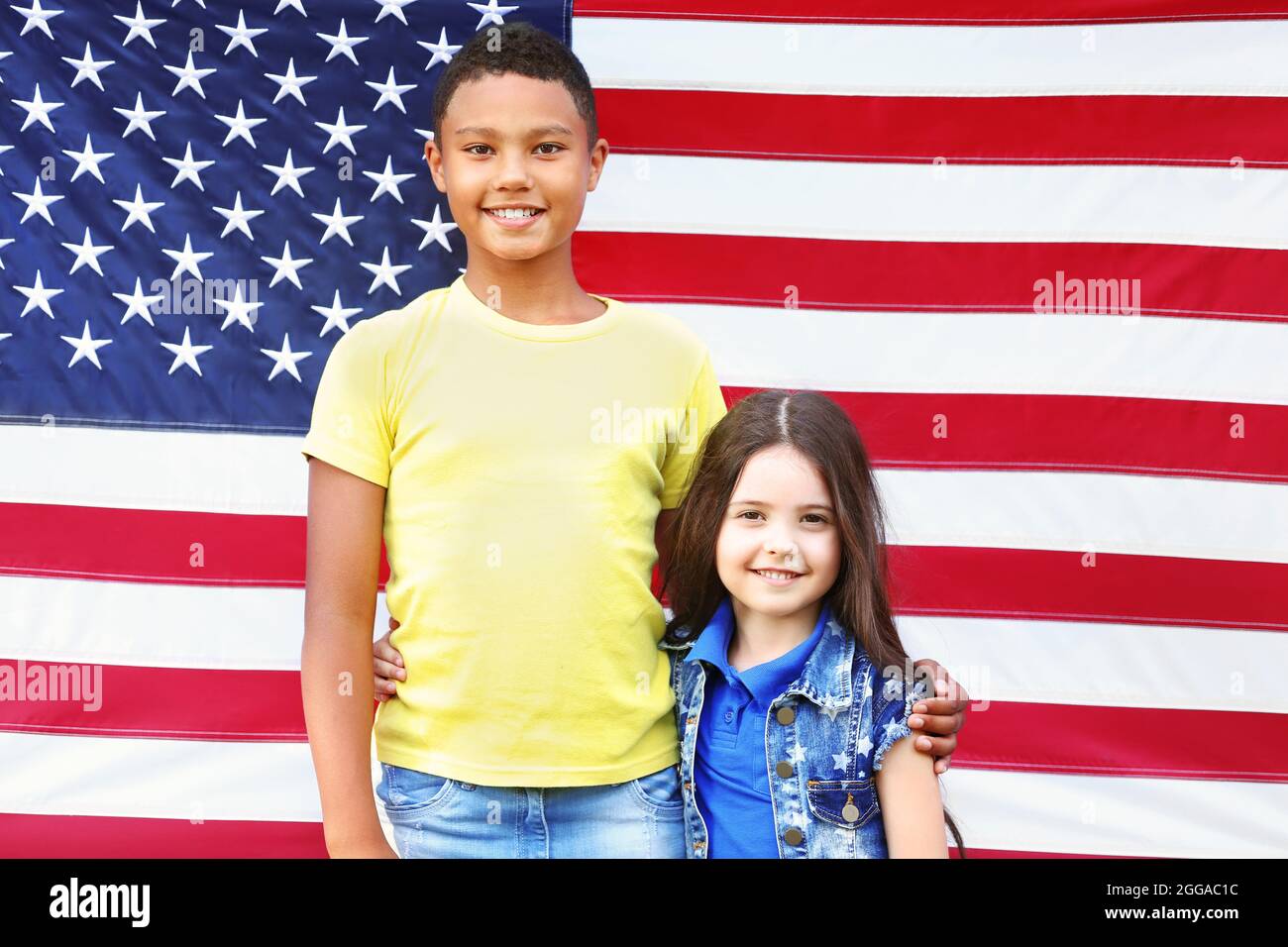 Boy and girl on American flag background Stock Photo - Alamy