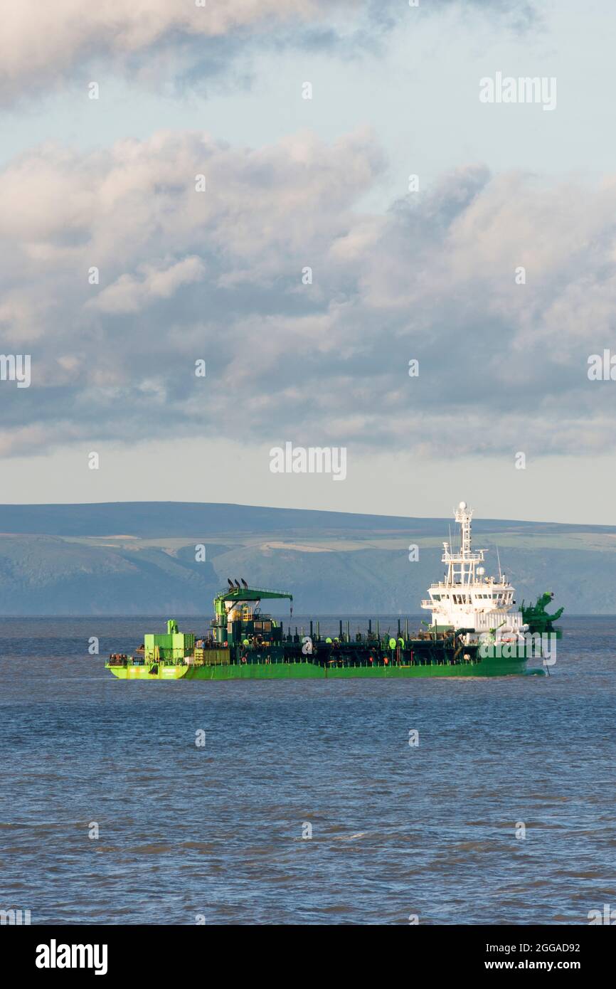 Dredger, the Artevelde, in the Bristol Channel off the coast of Barry near Cardiff. Somerset visible in the background. Stock Photo