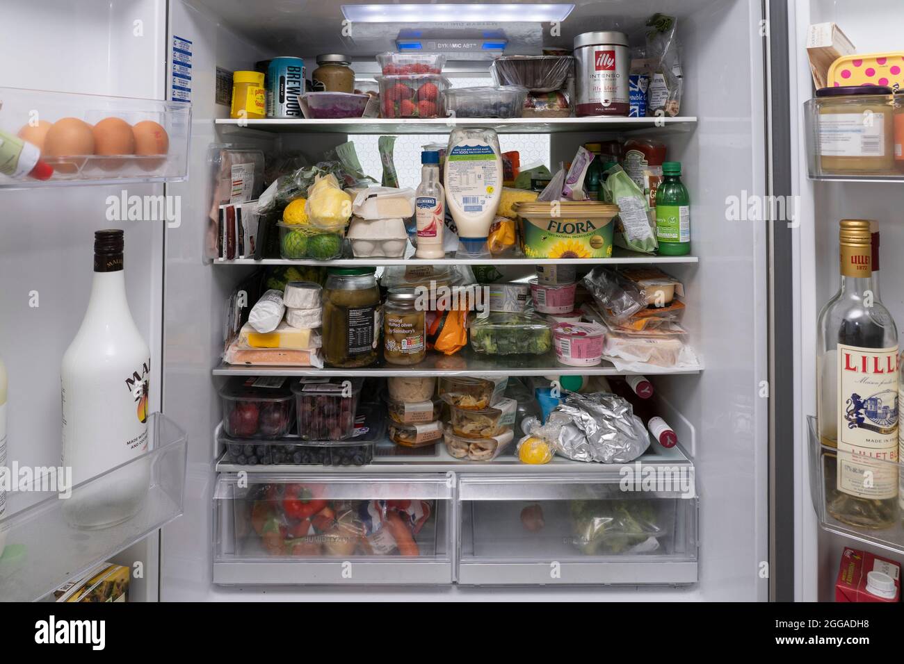 The interior of a UK fridge with shelves filled with a selection of
