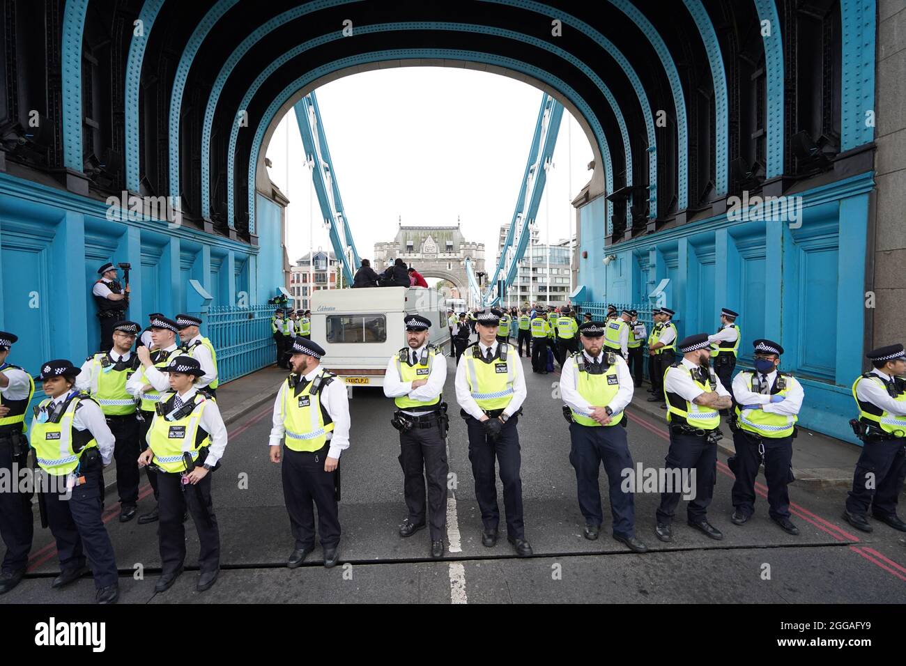 Police by a caravan on Tower Bridge, central London after members of ...