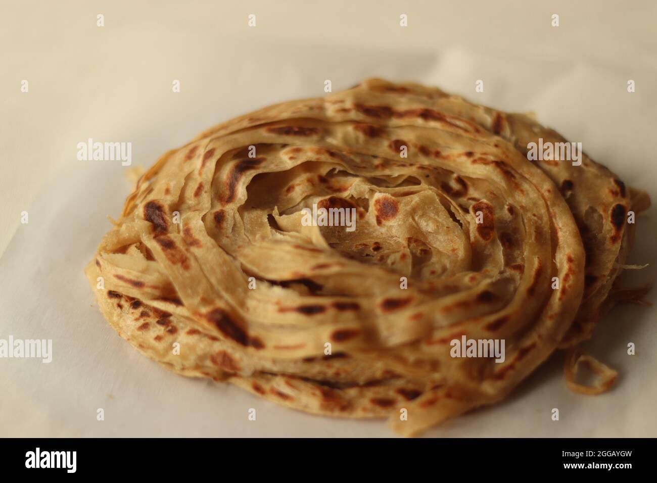 Parotta or Porotta is a layered flatbread made from Maida or Atta, alternatively known as flaky ribbon pancake. It is a favourite food item of Kerala. Stock Photo