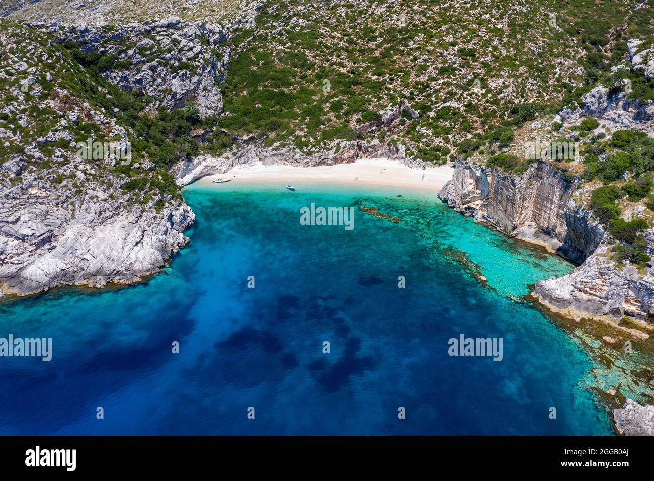 Aerial view of spectacular beach on a isolated karaburun peninsula and tourists, exploring it by speedboat, albania Stock Photo