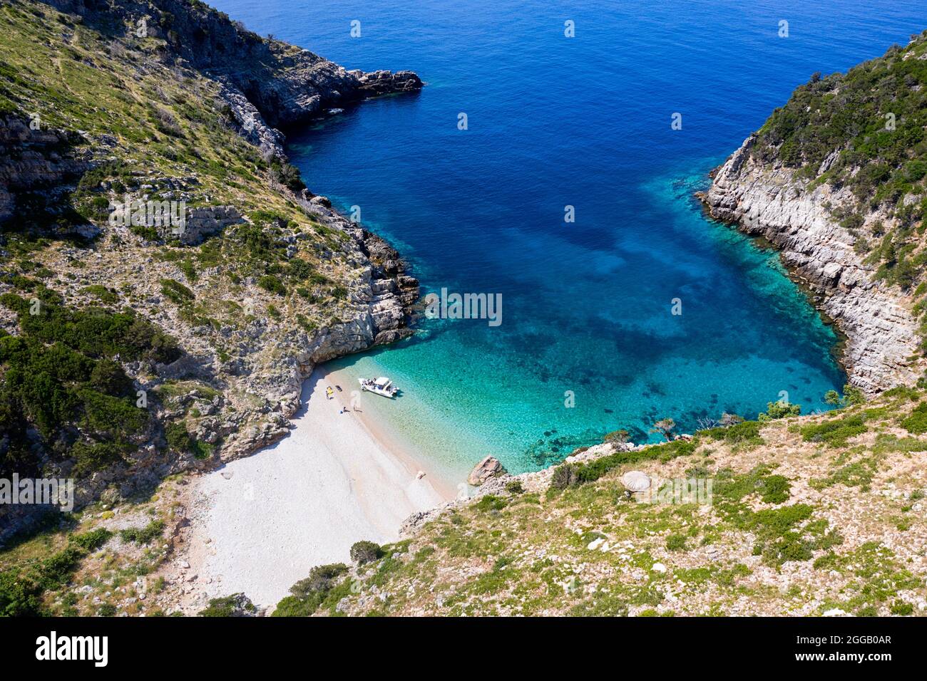 Aerial view of spectacular beach on a isolated karaburun peninsula and tourists, exploring it by speedboat, albania Stock Photo