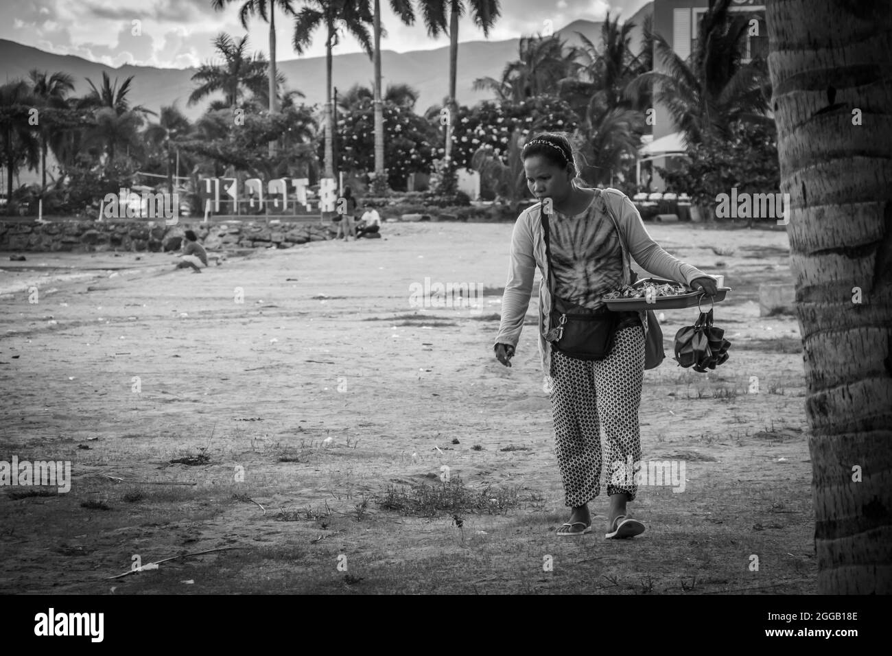 SUBIC, PHILIPPINES - Aug 09, 2017: A grayscale of a female vendor selling souvenirs at the beach of Subic Bay in Olongapo City, Zambales, Philippines Stock Photo