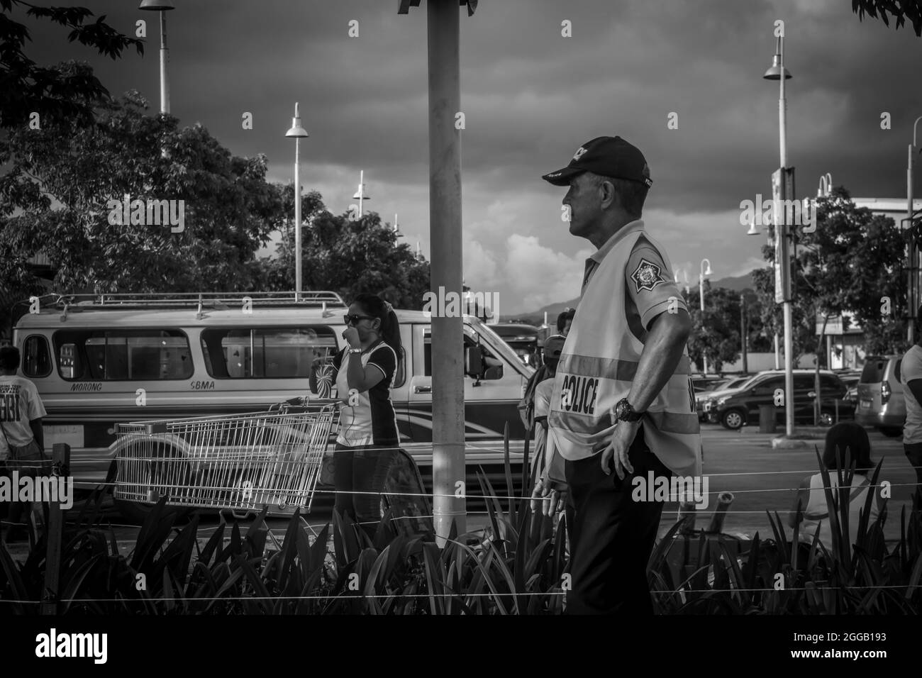 SUBIC, PHILIPPINES - Aug 09, 2017: A gray scale view of a police officer standing  in Olongapo City Zambales,  Philippines Stock Photo