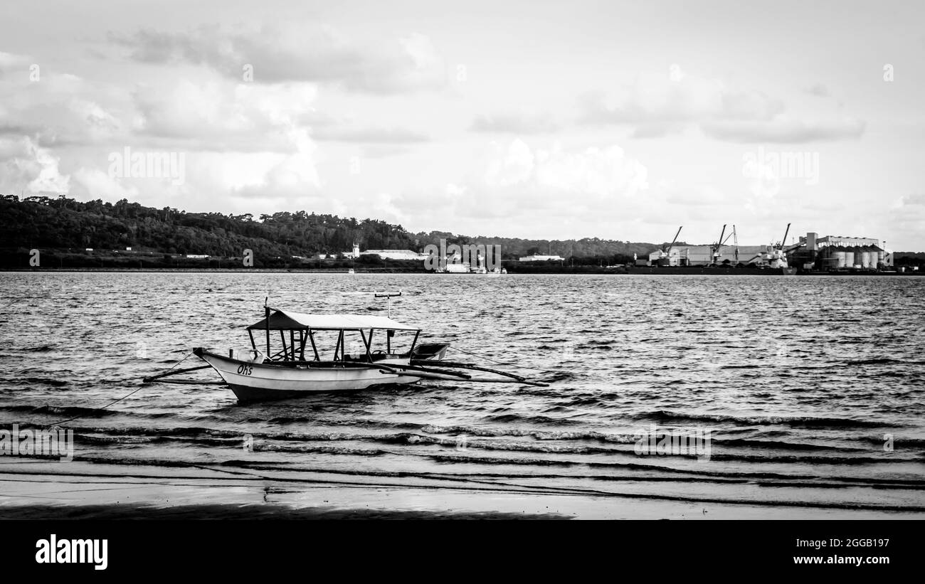 SUBIC, PHILIPPINES - Aug 09, 2017: A grayscale of a fishing boat at the beach of Subic Bay in Olongapo City, Zambales, Philippines. Stock Photo